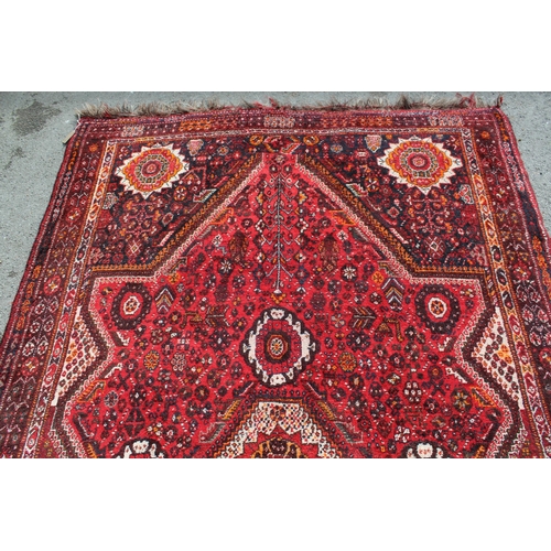 60A - Shiraz carpet with a medallion and all-over floral design, 9ft x 7ft approximately