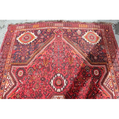 60A - Shiraz carpet with a medallion and all-over floral design, 9ft x 7ft approximately