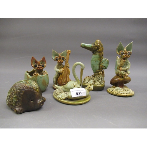 631 - Yare pottery figure of a stork delivering a baby dragon, together with five other similar items