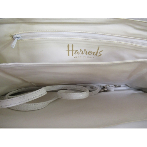 69 - Lulu Guinness, blue leather handbag with dust bag, together with a Harrods white shoulder bag (at fa... 