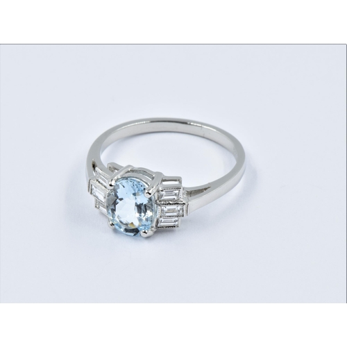 917 - Platinum ring set with a central oval aquamarine flanked each side by 3 baguette horizontal diamonds... 