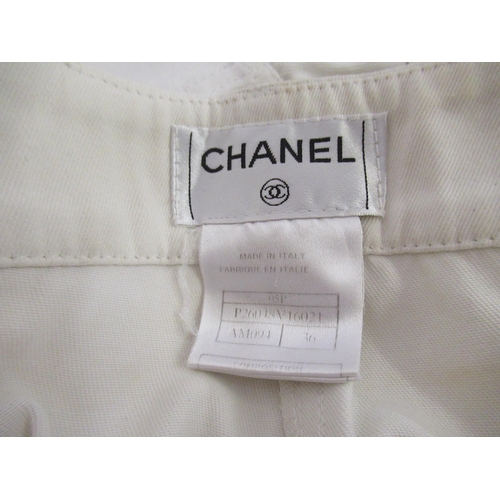 94 - Chanel, pair of ladies white jeans, size 36 together with a Chanel navy blue skirt with buttons in t... 