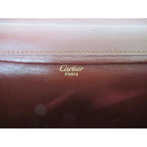 97 - Must de Cartier bordeaux leather pouch, with authenticity card and dust bag