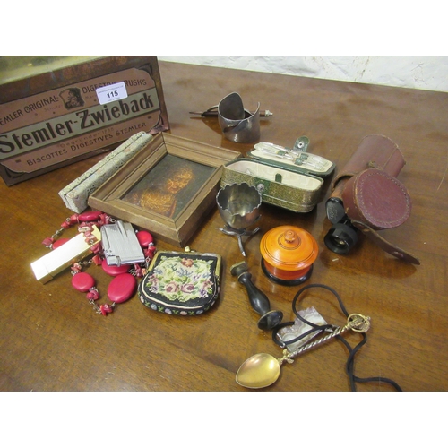 115 - Tin containing a quantity of miscellaneous collectables including a monocular, needlepoint evening b... 