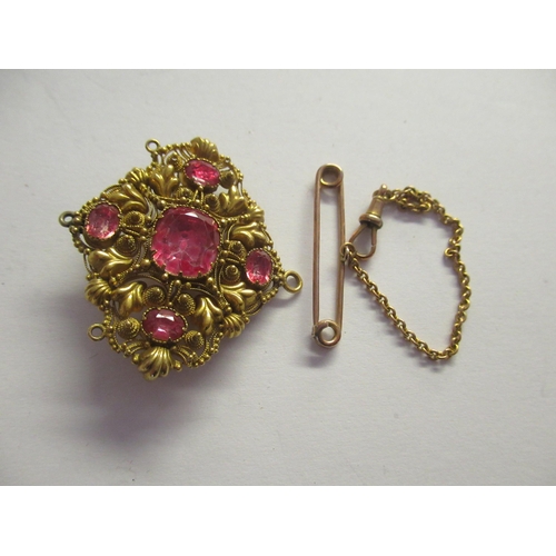 910 - Unmarked yellow metal bar and chain, yellow metal filigree and pink paste pendant and an antique pas... 