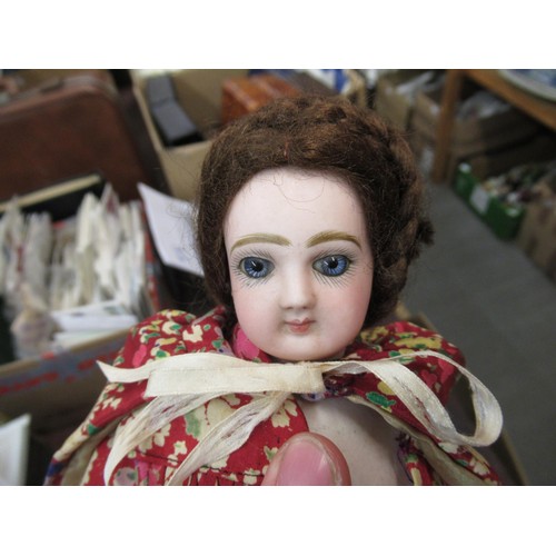 199 - Small late 19th / early 20th Century bisque headed doll with fixed eyes and kid leather body, wearin... 