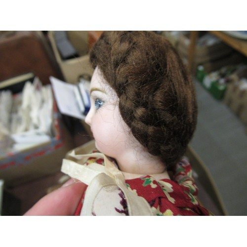 199 - Small late 19th / early 20th Century bisque headed doll with fixed eyes and kid leather body, wearin... 