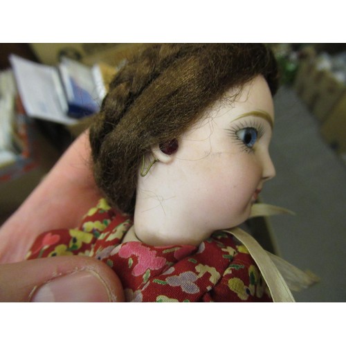 199 - Small late 19th / early 20th Century bisque headed doll with fixed eyes and kid leather body, wearin... 