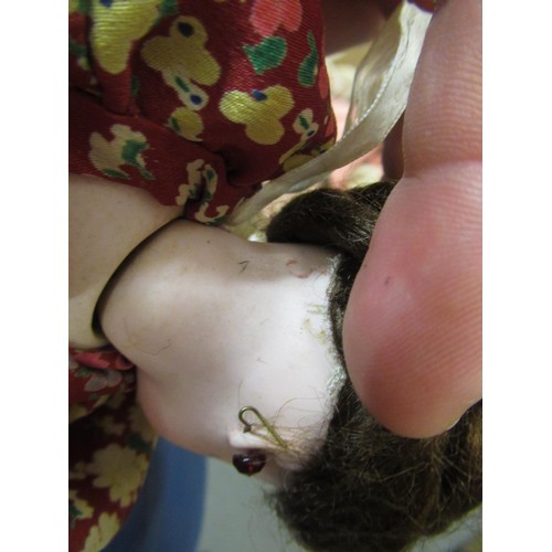 199 - Small late 19th / early 20th Century bisque headed doll with fixed eyes and kid leather body, wearin... 