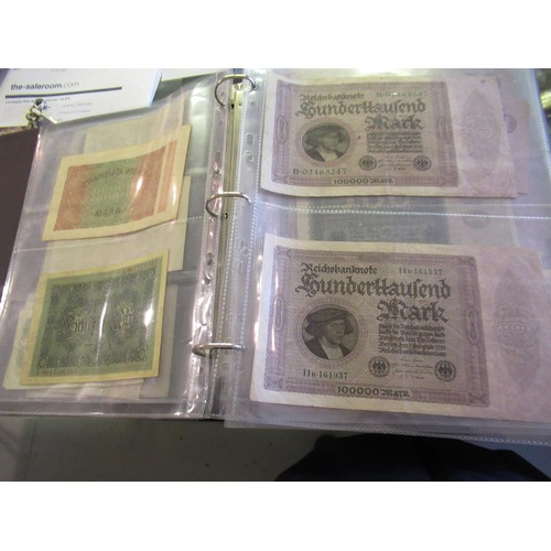 974 - Two albums containing a large quantity of various British and World bank notes, together with a bag ... 