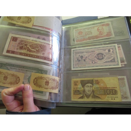 974 - Two albums containing a large quantity of various British and World bank notes, together with a bag ... 