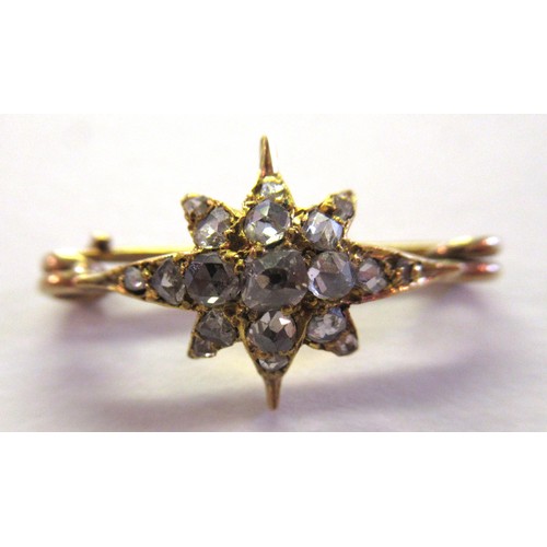 909 - Miniature yellow metal and rose cut diamond set star form brooch, overall width 25mm approximately