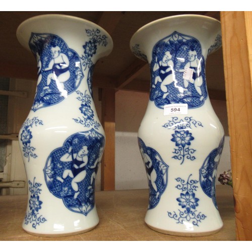 594 - Pair of Chinese blue and white baluster form flared rim vases decorated with panels of figures, bear... 