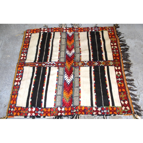 1 - Small part piled rug with a four panel design and tassel border, 4ft 8ins x 4ft 2ins approximately t... 