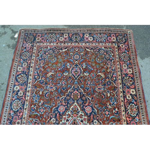 10 - Kashan rug with a lobed medallion and all-over stylised floral design on a red ground with borders, ... 
