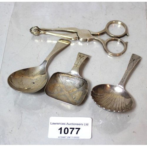 1077 - Two antique silver caddy spoons (marks indistinct), together with a later Birmingham silver caddy sp... 