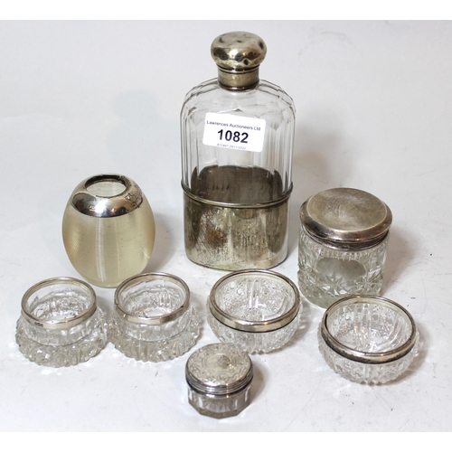 1082 - Cut glass hip flask with silver mounted top and plated cup, together with a quantity of other silver... 