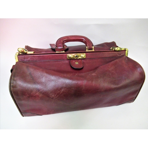 109 - Etienne Aigner, late 20th Century leather and brass mounted Gladstone type bag, 16ins wide approxima... 