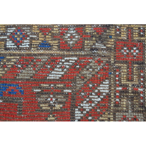 11 - Kazak runner with an all-over stylised flowerhead design on a red ground with borders, 12ft 10ins x ... 