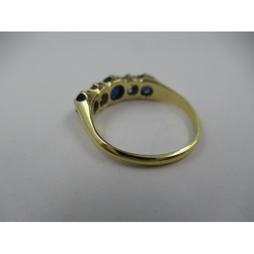 1114 - 18ct Yellow gold five stone sapphire and diamond half hoop ring, size O