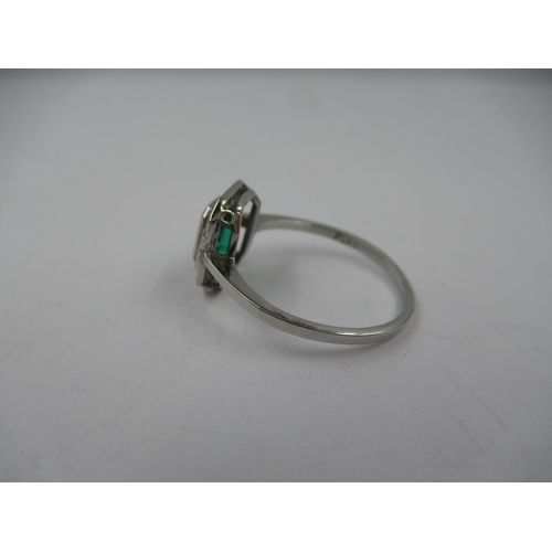 1121 - Platinum ring set with central octagonal emerald surrounded by diamonds, size N