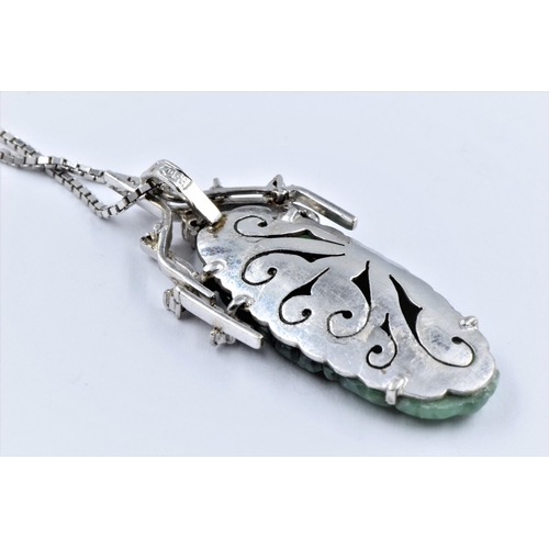 1135 - Oriental 9ct white gold diamond and jade pendant on chain, the pendant 38mm