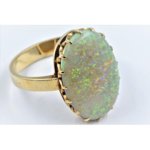 1140 - 9ct Gold ring set large oval opal of good colour, approximately 21 x 14mm overall, size 'R'