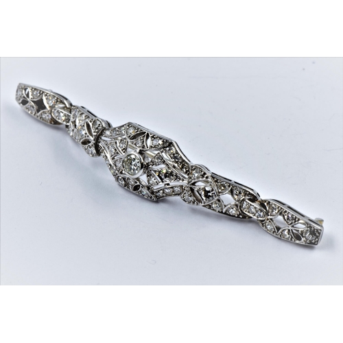 1142 - High carat white metal and diamond set bar brooch of Art Deco design, set with a variety of brillian... 