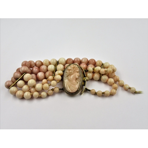 1144 - Victorian triple row angel skin coral graduated bead bracelet with cameo clasp set in yellow metal, ... 