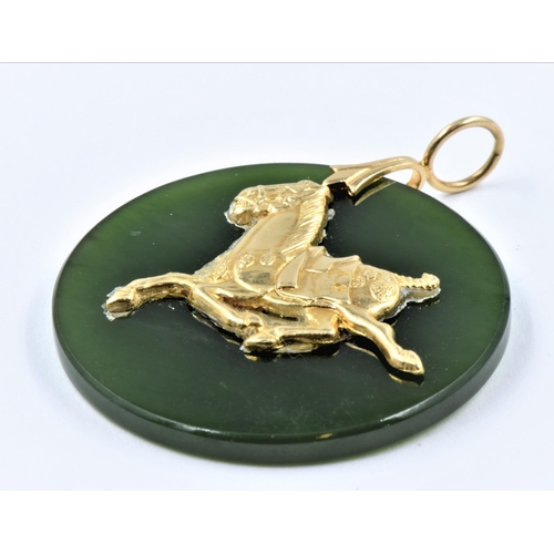 1145 - Circular jade pendant, mounted with a gold figure of a horse, 32mm diameter