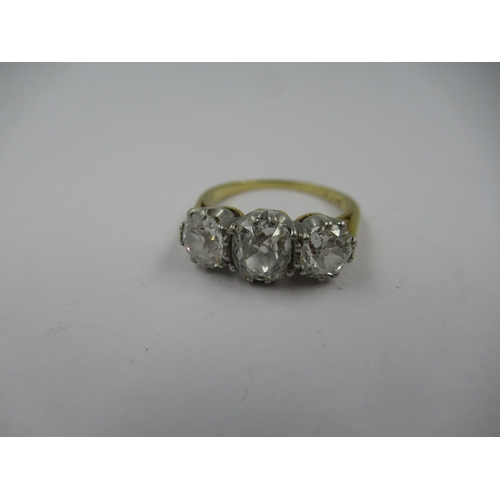 1252 - 18ct Gold and platinum three stone old cut diamond ring, the centre stone of approximately 0.5ct, fl... 