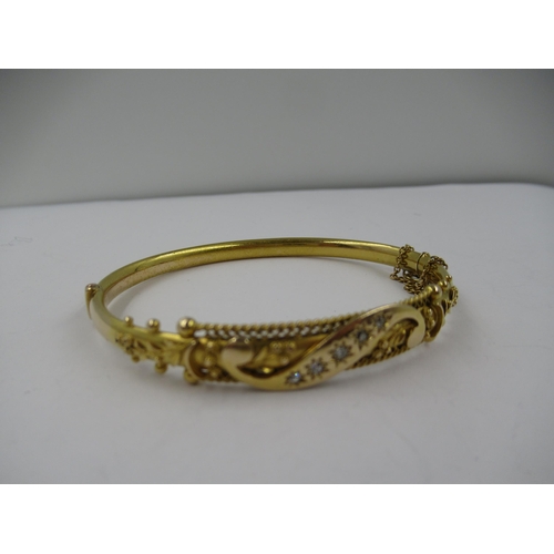 1253 - Edwardian 15ct gold and diamond set bangle, interior dimensions 60 x 50mm, 9.2gms