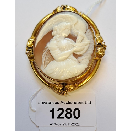 1280 - 19th Century yellow metal mounted cameo brooch, carved with a scene depicting a female figure, feedi... 