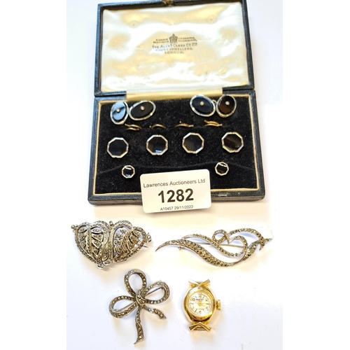 1282 - Cased black onyx white metal and split pearl cufflink and stud set, together with two marcasite broo... 