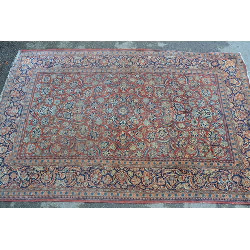 13 - Tabriz rug with a medallion and all-over floral design on a red ground with borders, 6ft 8ins x 4ft ... 