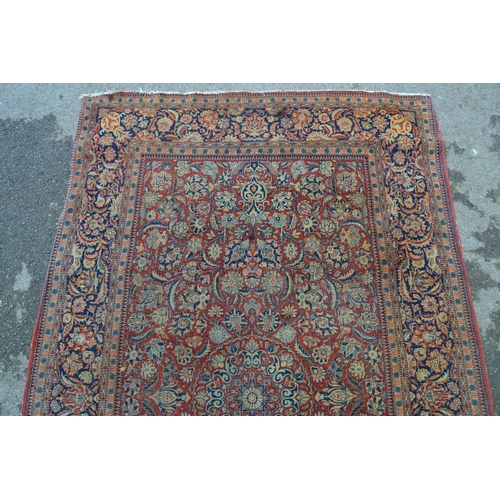 13 - Tabriz rug with a medallion and all-over floral design on a red ground with borders, 6ft 8ins x 4ft ... 