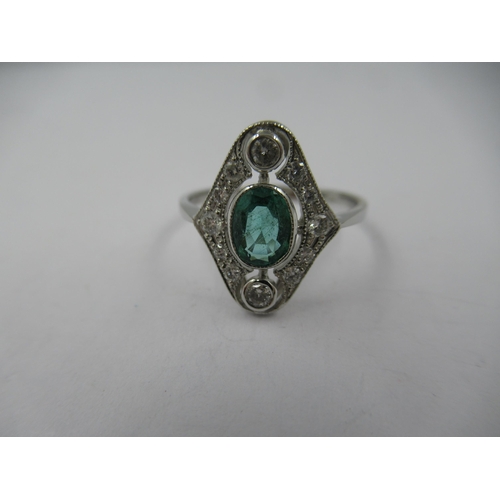 1305 - Platinum ring set single oval emerald surrounded by diamonds in a pierced setting, size N