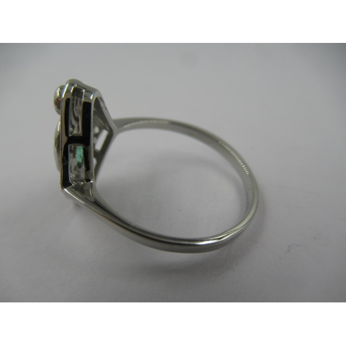 1305 - Platinum ring set single oval emerald surrounded by diamonds in a pierced setting, size N