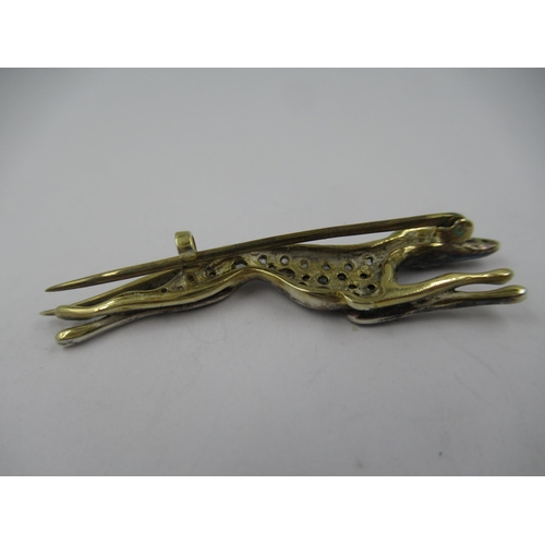 1306 - 9ct Yellow gold and silver mounted brooch in the form of a greyhound set rose cut diamonds