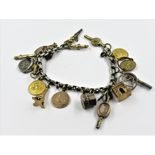 1328 - Silver charm bracelet with various silver gilt and silver charms and six watch keys