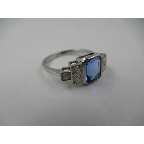 1399 - Deco style platinum rubover ring set central tanzanite flanked on each side by three diamonds, size ... 