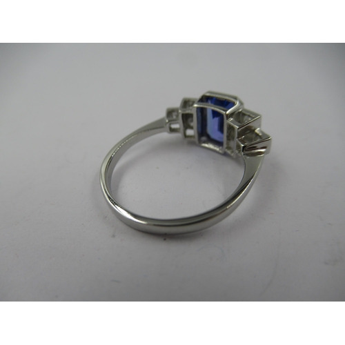 1399 - Deco style platinum rubover ring set central tanzanite flanked on each side by three diamonds, size ... 