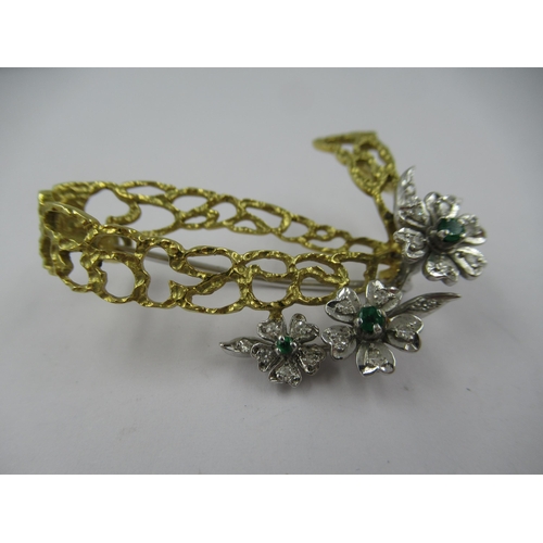 1402 - 18ct Two colour gold flower brooch set emeralds and diamonds, 9g