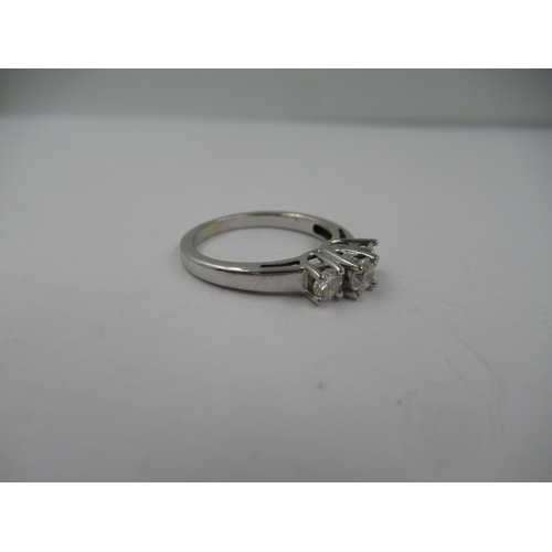 1432 - 14ct White gold ring set three brilliant cut diamonds, size 'K'