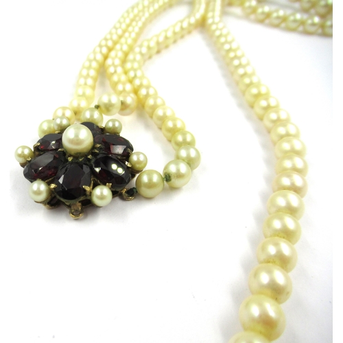 1436 - Two row cultured pearl necklace with a 9ct gold garnet set clasp