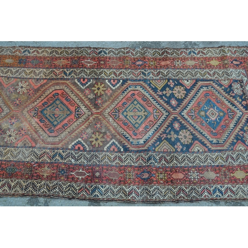 15 - Kurdish rug with a triple medallion design in shades of rose, beige and dark blue, 6ft 6ins x 3ft 6i... 