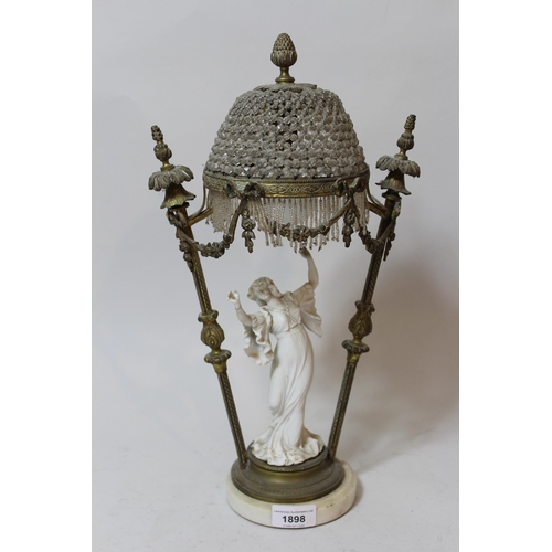 1898 - Brass and porcelain mounted table lamp in the form of a dancing girl beneath a canopy (at fault)