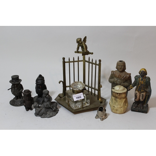 1902 - Brass inkwell surmounted by a figure of a cherub above a railing, together with a silvered metal fig... 