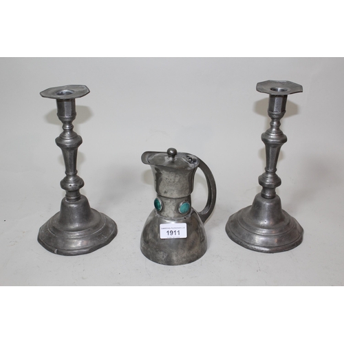 1911 - Pair of pewter candlesticks, an Arts & Crafts pewter and enamel jug marked Terry, Manchester togethe... 