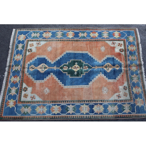 2 - Modern Turkish carpet with a central lobed medallion design on a terracotta ground with blue ground ... 